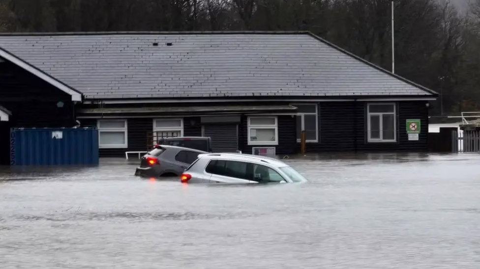Courtesy of BBC News: Cars have been lifted off their wheels after the Ebbw River burst its banks and flooded Pandy Park at Cross Keys, near Newport
